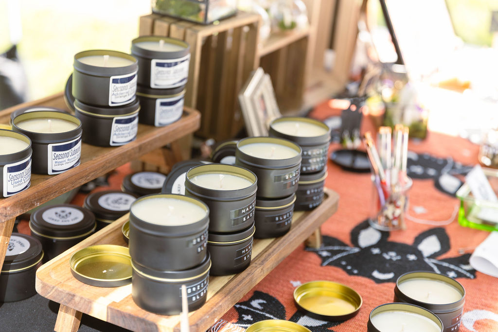 Handmade candles on a vendor table