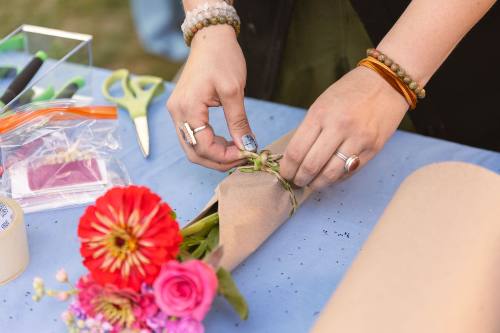 Vendor wrapping a fresh flower bouquet
